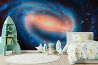 Galaxy Dream wallpaper mural of a spiral galaxy in a kids room with a mint rocket shelf and star rug