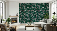 Gecko Groove wallpaper in dark green behind a grey sectional sofa by a fireplace in a bright living room