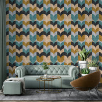 Geometric Art wallpaper of teal and ochre shapes behind a sage Chesterfield sofa and leather chair in a lounge
