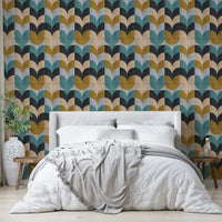 Geometric Art wallpaper of teal and ochre petals behind a cream upholstered bed with a grey striped throw