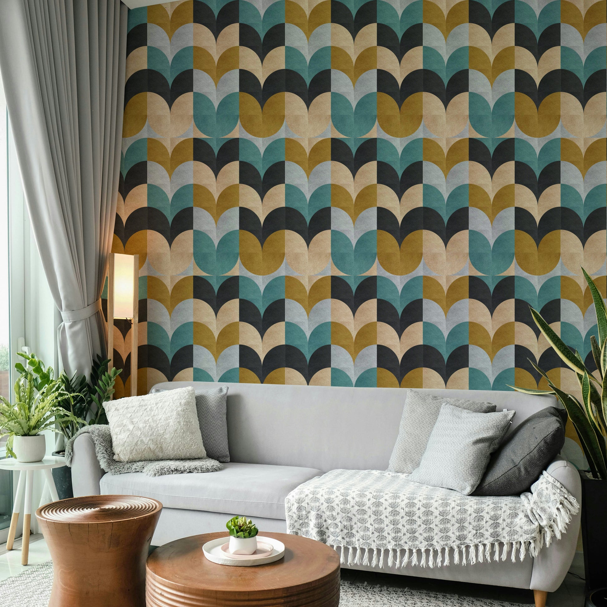 Geometric Art wallpaper with retro petal blocks behind a light grey sofa and wooden tables in a living room
