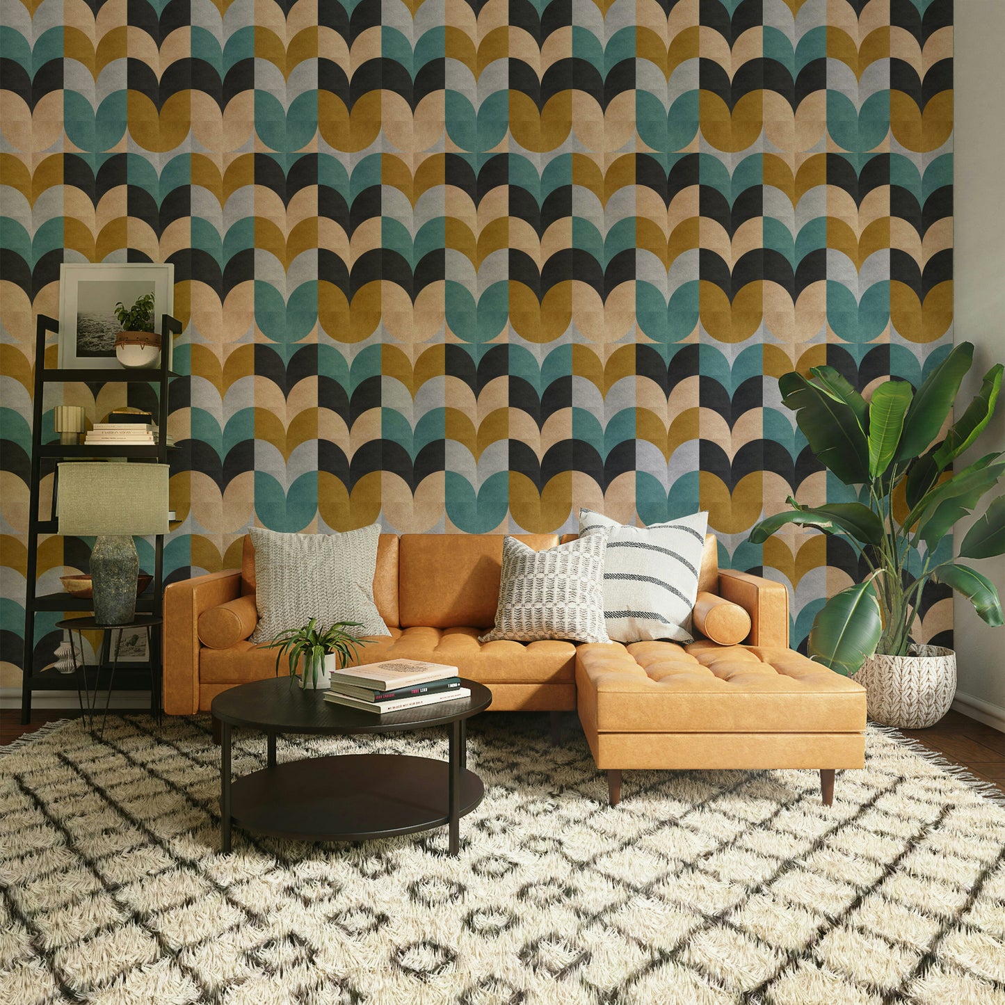 Geometric Art wallpaper of teal and mustard shapes behind a caramel leather sofa and palm in a living room