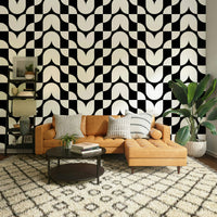 A dining room decorated with a geometric wallpaper

