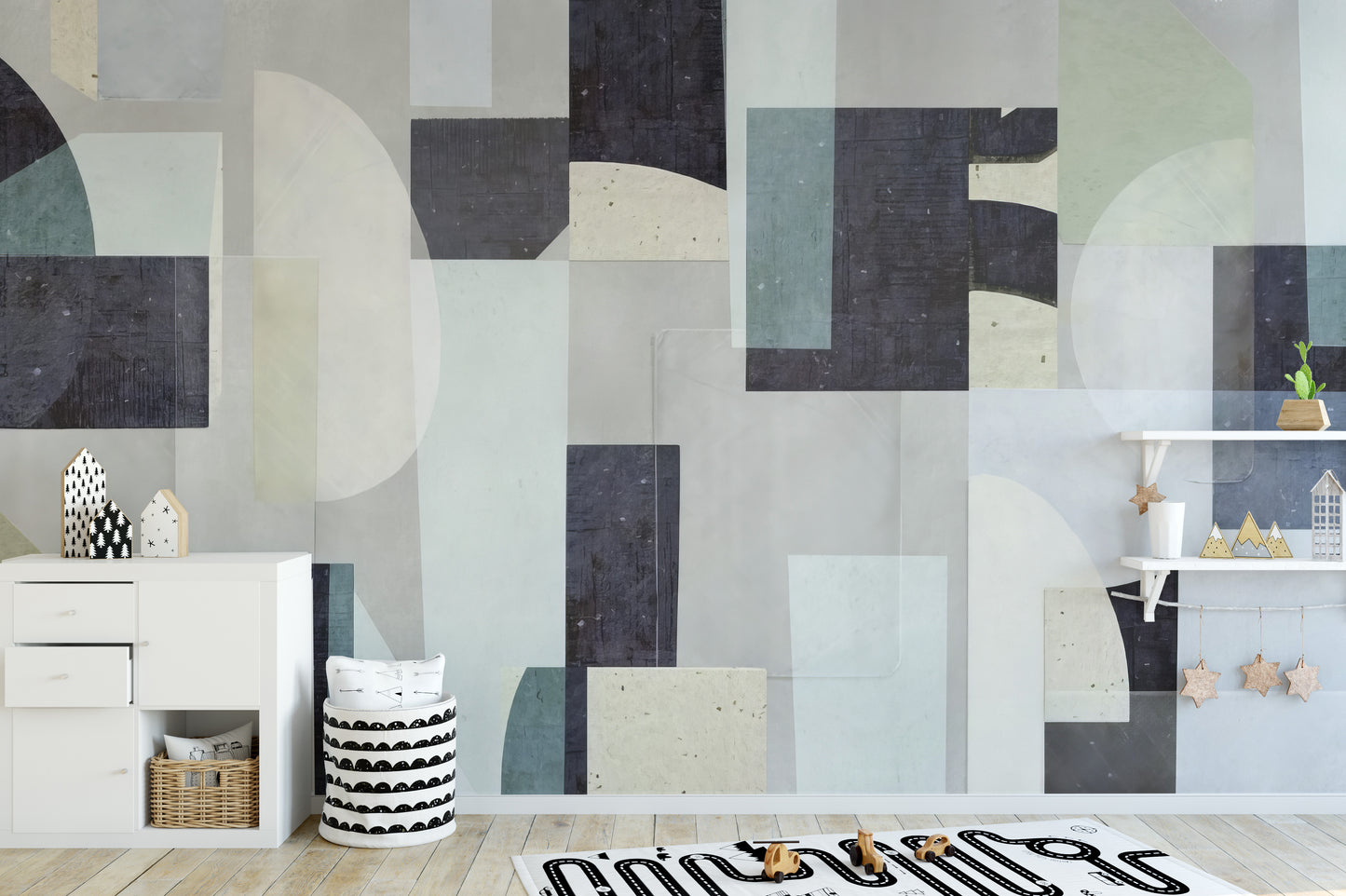 Abstract Geometric wallpaper mural with navy and sage blocks in a kids room with a white dresser and toy shelf