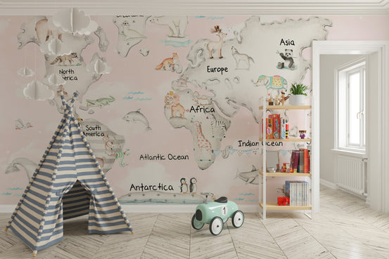 Cuddly Creatures Atlas wallpaper mural of a pink animal world map in a playroom with a striped teepee and ride-on car