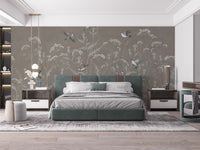Meadow Melody wallpaper mural with sparrows and wildflowers above a green velvet bed in a modern bedroom