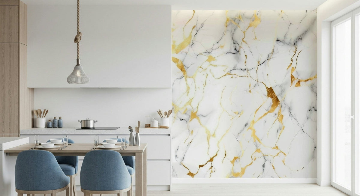 Gilded Marble Swirl wallpaper mural in white and gold veining on a kitchen wall beside a dining table with blue chairs