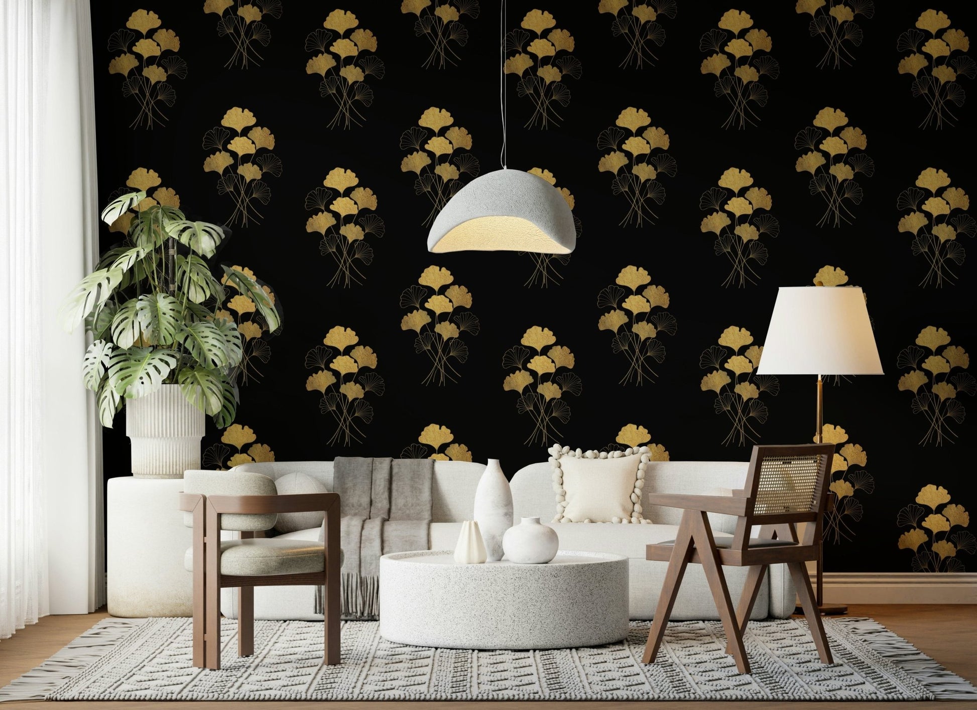 Ginkgo Luxury Gold wallpaper mural with gold ginkgo motifs on black behind a white sofa and cane chairs in a living room