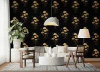 Ginkgo Luxury Gold wallpaper mural with gold ginkgo motifs on black behind a white sofa and cane chairs in a living room