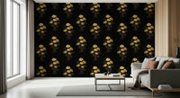 Ginkgo Luxury Gold wallpaper mural of gold ginkgo sprays on black behind a gray sofa and wood table in a bright living room