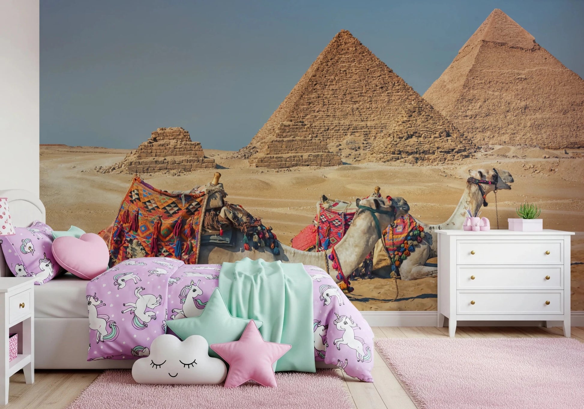 Giza wall mural of the pyramids and camels in a girls room with purple unicorn bedding and pastel cushions