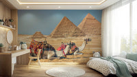 Giza wall mural of the pyramids and saddled camels behind a mint-trimmed bed and wood desk in a bedroom