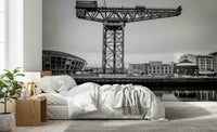 Large cityscape wallpaper behind sofa in apartment, muted colours, Glasgow-inspired urban mural