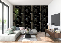 Golden Arcadia Harmony Deco wallpaper in black and gold deco pattern behind a grey sectional with wood TV console