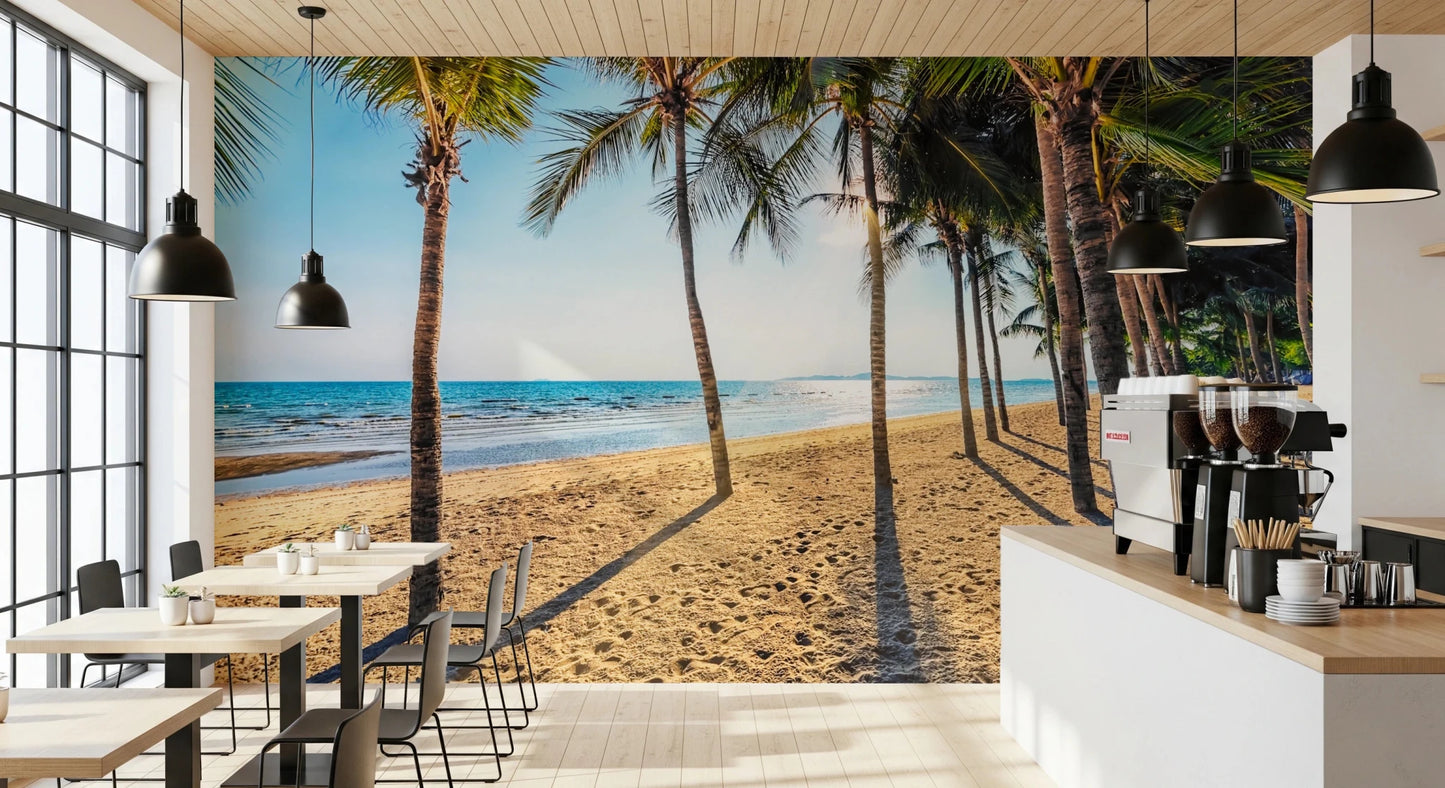 Golden Beach Palms wallpaper mural of a tropical beach in a cafe with black pendant lights and small tables