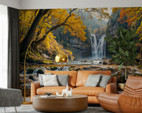 Golden Falls wallpaper mural of an autumn waterfall behind a cognac leather sofa and gold arc lamp