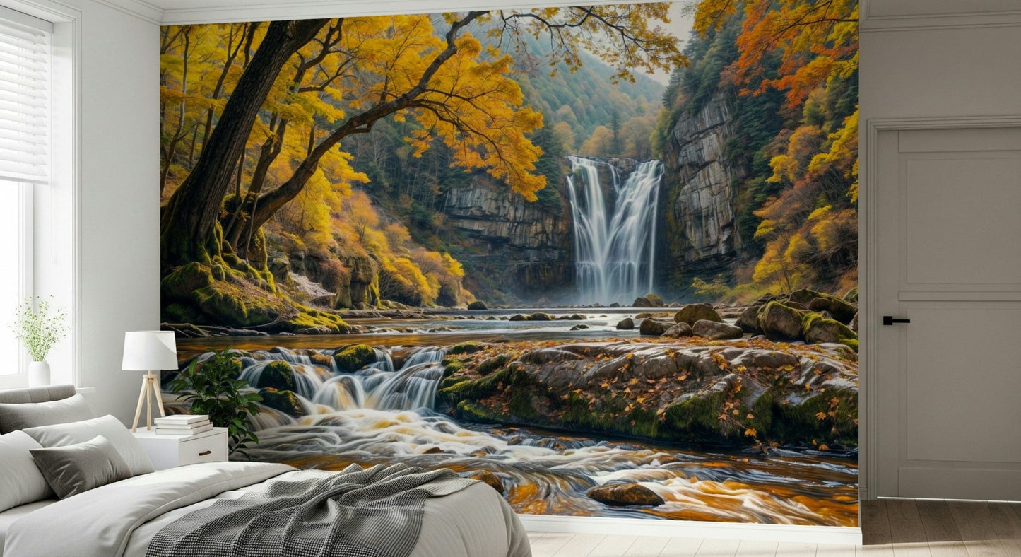 Golden Falls wallpaper mural of a waterfall and autumn forest behind a low gray bed in a bedroom