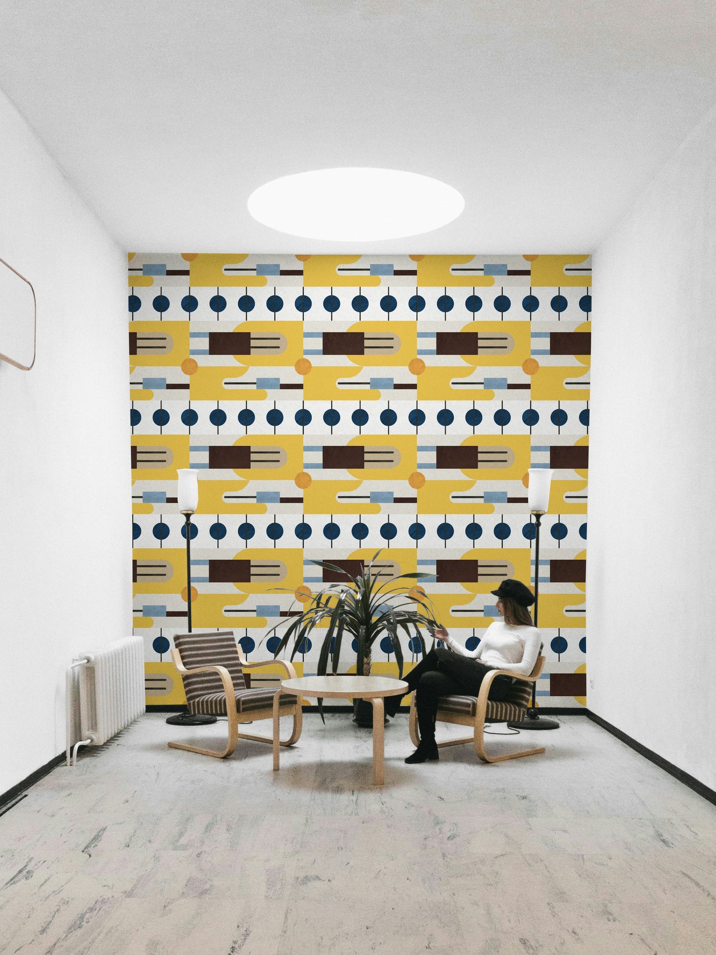 Golden Hour Hues wallpaper as a full-wall mural behind two wooden armchairs and a potted palm in a lounge