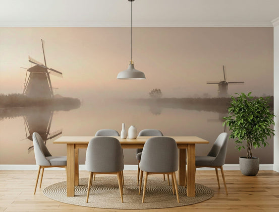 Golden Hour Windmills wallpaper mural of misty Dutch windmills reflected in a canal behind a wood dining table and grey chairs