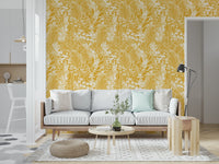 Golden Meadow Dream wallpaper in yellow and white behind a pale grey sofa with mint cushions and pouf