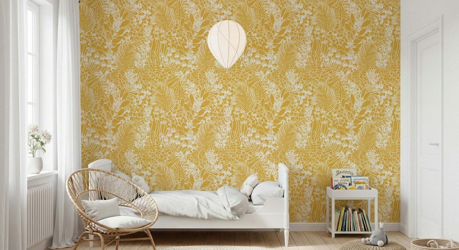 Golden Meadow Dream wallpaper in soft yellow leaves in a kids room with a white bed and rattan chair