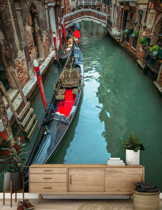 Gondola resting in canal mural, charming bridge spanning water.
