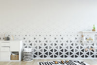 Geometric pattern play room wall mural with interlocking matte grey triangles.