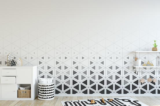 Geometric pattern play room wall mural with interlocking matte grey triangles.