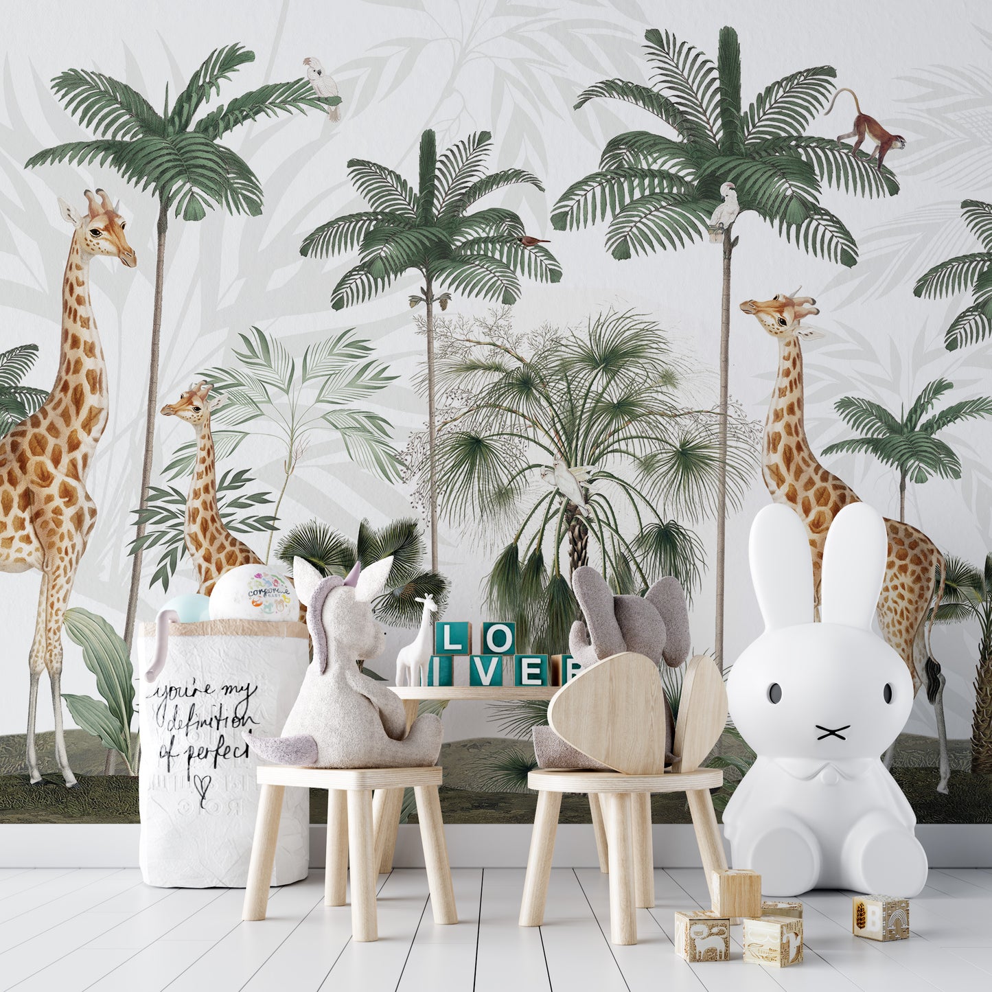 Gracious Giraffes wallpaper with palms and monkeys in a play area with plush toys and a bunny lamp
