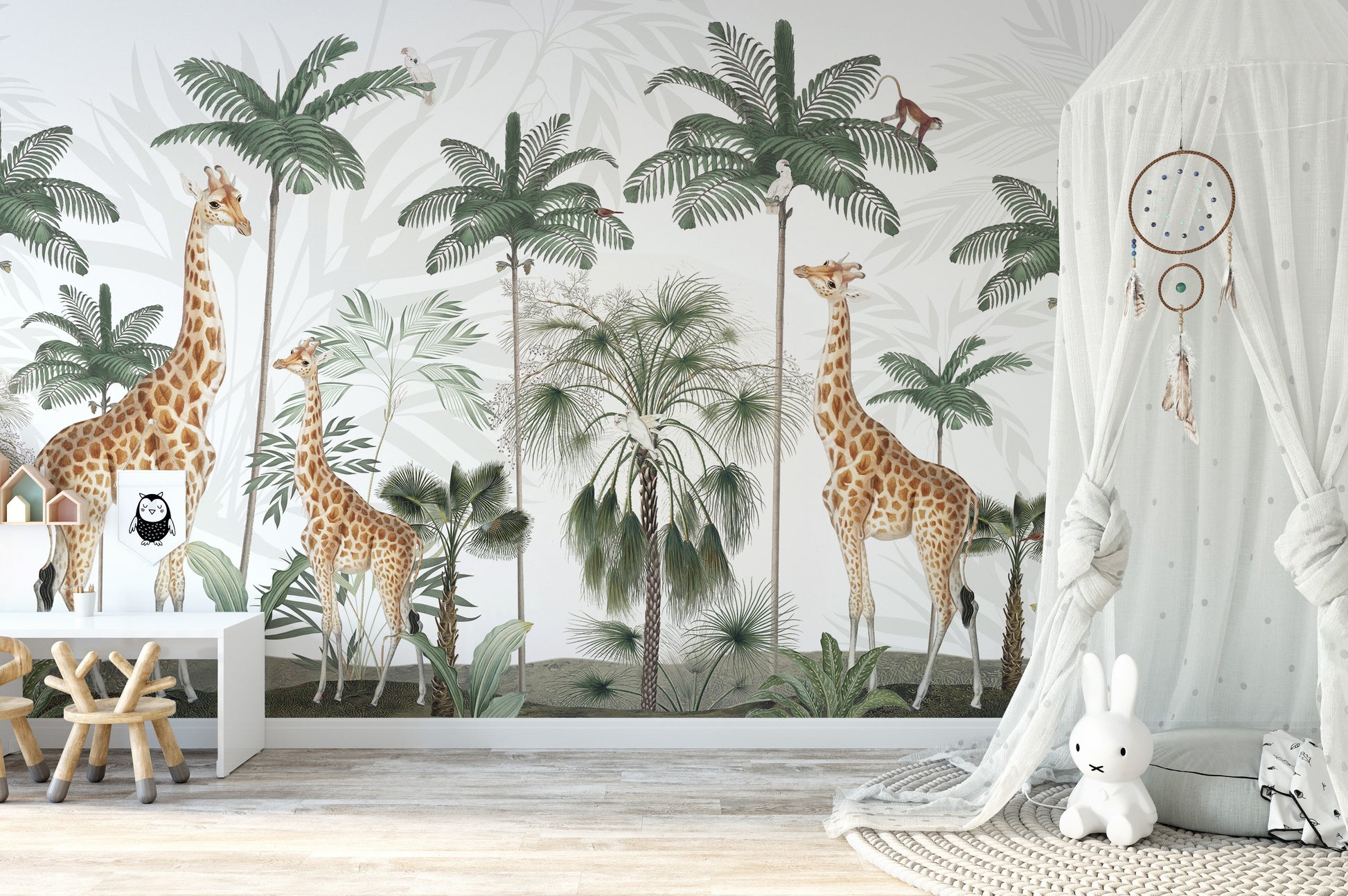 Gracious Giraffes wallpaper jungle scene in a nursery with a white play desk and canopy teepee
