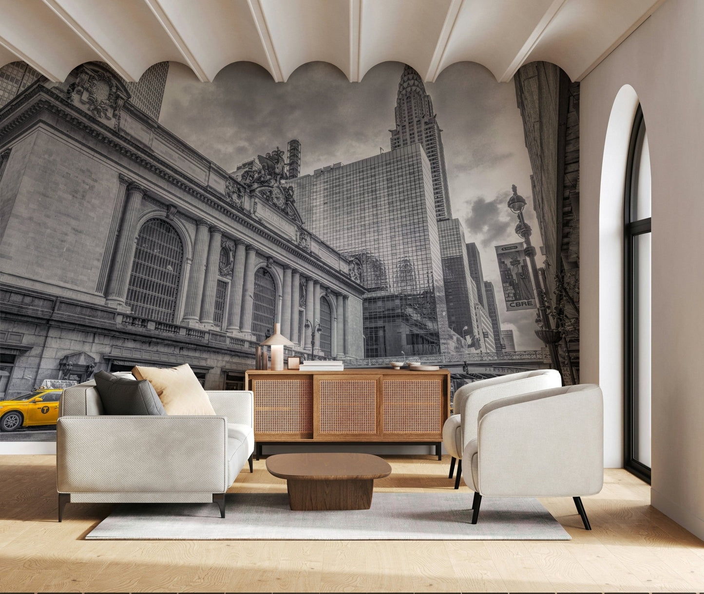 Grand Central Terminal mural in a living room with a cream sofa, rattan sideboard and scalloped ceiling