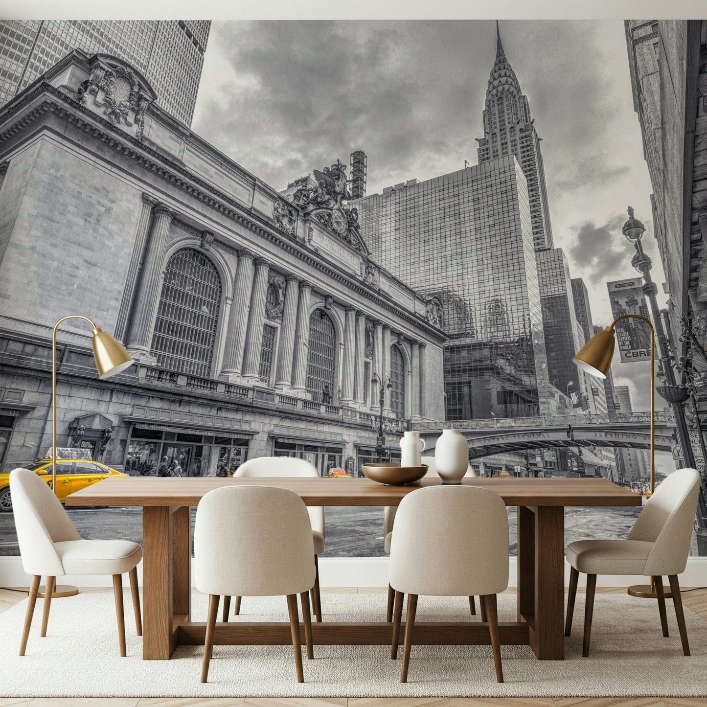 Grand Central Terminal mural behind a wood dining table, cream chairs and brass floor lamps in a dining room