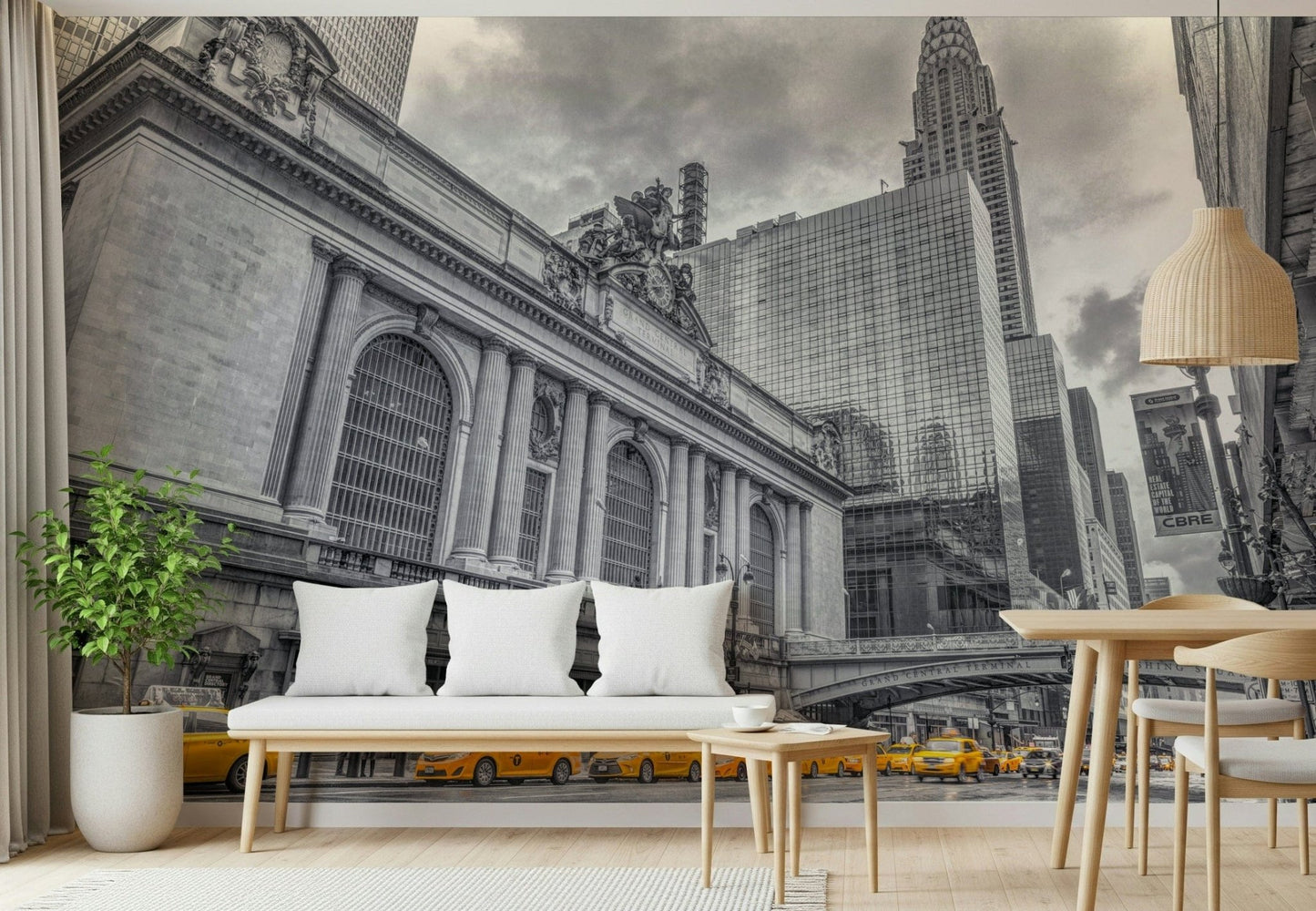 Grand Central Terminal mural in an entryway with a white cushioned bench and a potted green plant