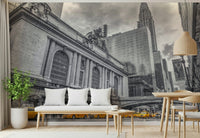 Grand Central Terminal mural in an entryway with a white cushioned bench and a potted green plant