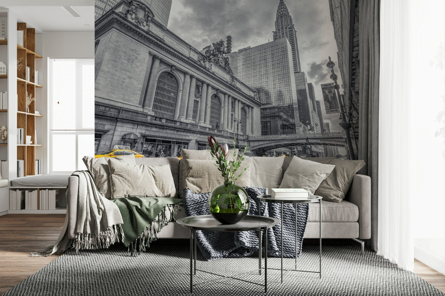 Grand Central Terminal mural above a beige sectional sofa with a green glass vase in a cozy living room