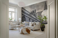 Grand Central Terminal mural in a bright living room with a cream sofa, tall potted plant and pendant lamp