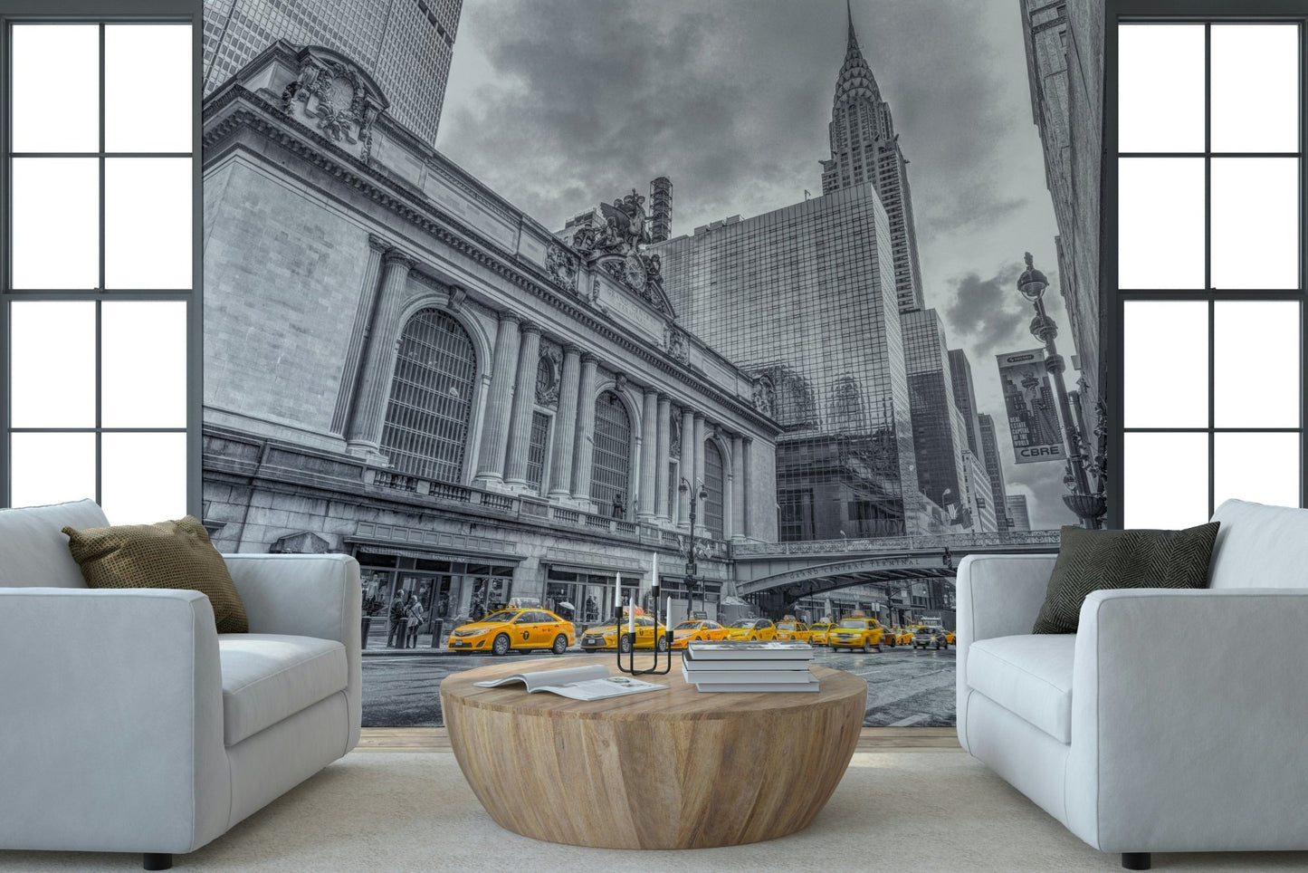 Grand Central Terminal mural with yellow cabs framed by two white armchairs and a round wood coffee table