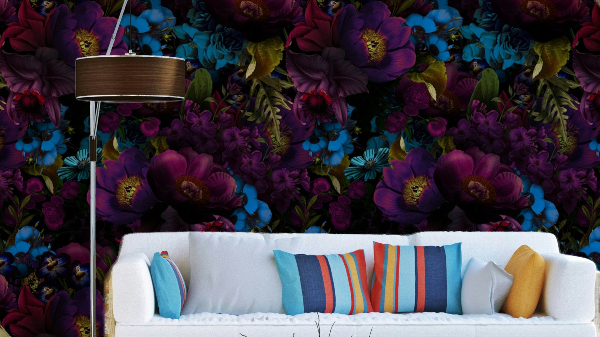 Gothic Dark Moody Florals wallpaper mural in purple and blue behind a white sofa with striped cushions