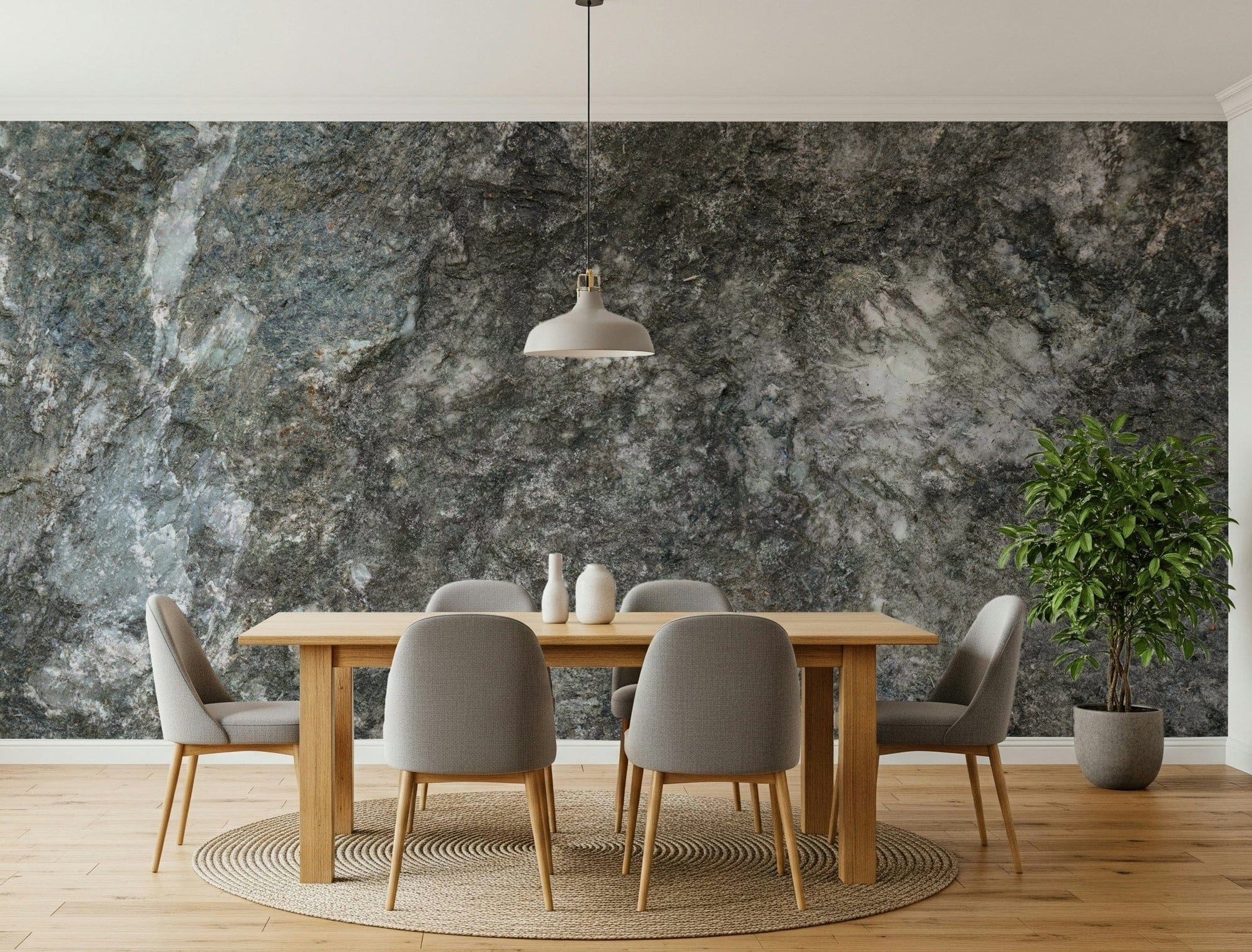 Granite depths wallpaper mural behind a light wood dining table with gray chairs and a white pendant