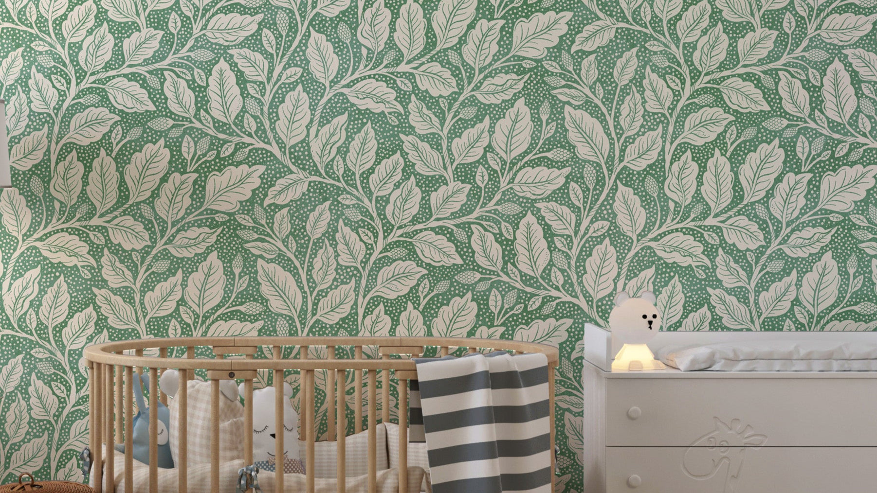 Green Budding Branches wallpaper with cream leafy vines on green in a nursery with a wooden crib and white dresser