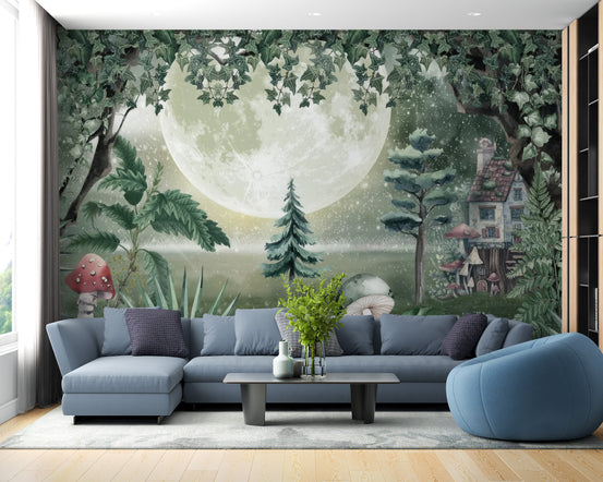 Green Magical Forest wallpaper mural with a glowing moon and fairytale cottage behind a blue sectional sofa