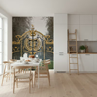 Close up of the detailed black iron gate and green foliage on a wall mural.