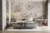 Grey Floral wallpaper of grey poppies behind a white upholstered bed beside a white vanity desk
