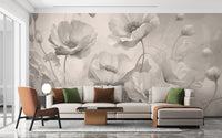 Grey Floral wallpaper of pale grey poppies behind a cream sectional sofa with green and rust pillows