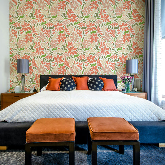 Groovy Flowers Coral Green wallpaper mural behind a black headboard bed with orange and navy pillows