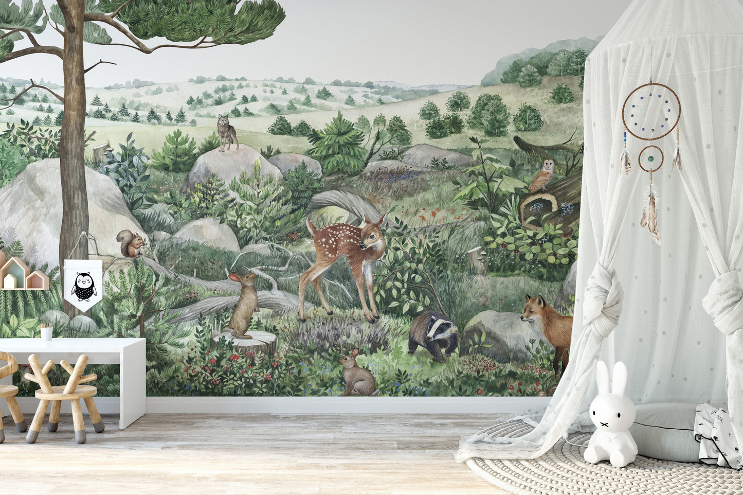 Happy Hills wallpaper mural showing a fawn, fox and owls in a nursery with a white canopy and Miffy bunny lamp