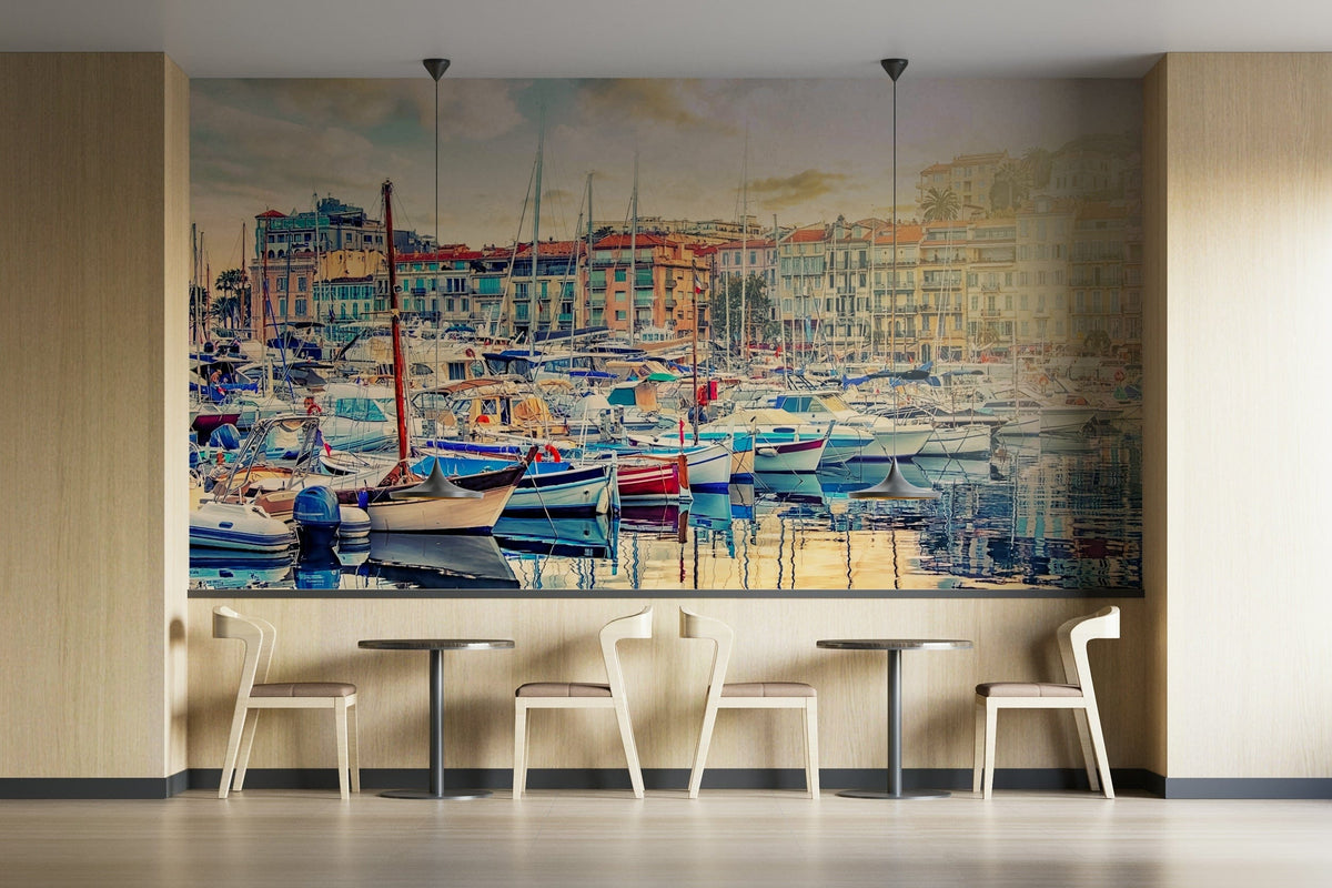 Harbor Serenity wallpaper mural of moored sailboats and pastel waterfront houses above wood chairs and tables in a cafe
