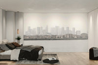 The color palette is composed of muted grays, soft blues, and subtle, diffused lights from the city.
