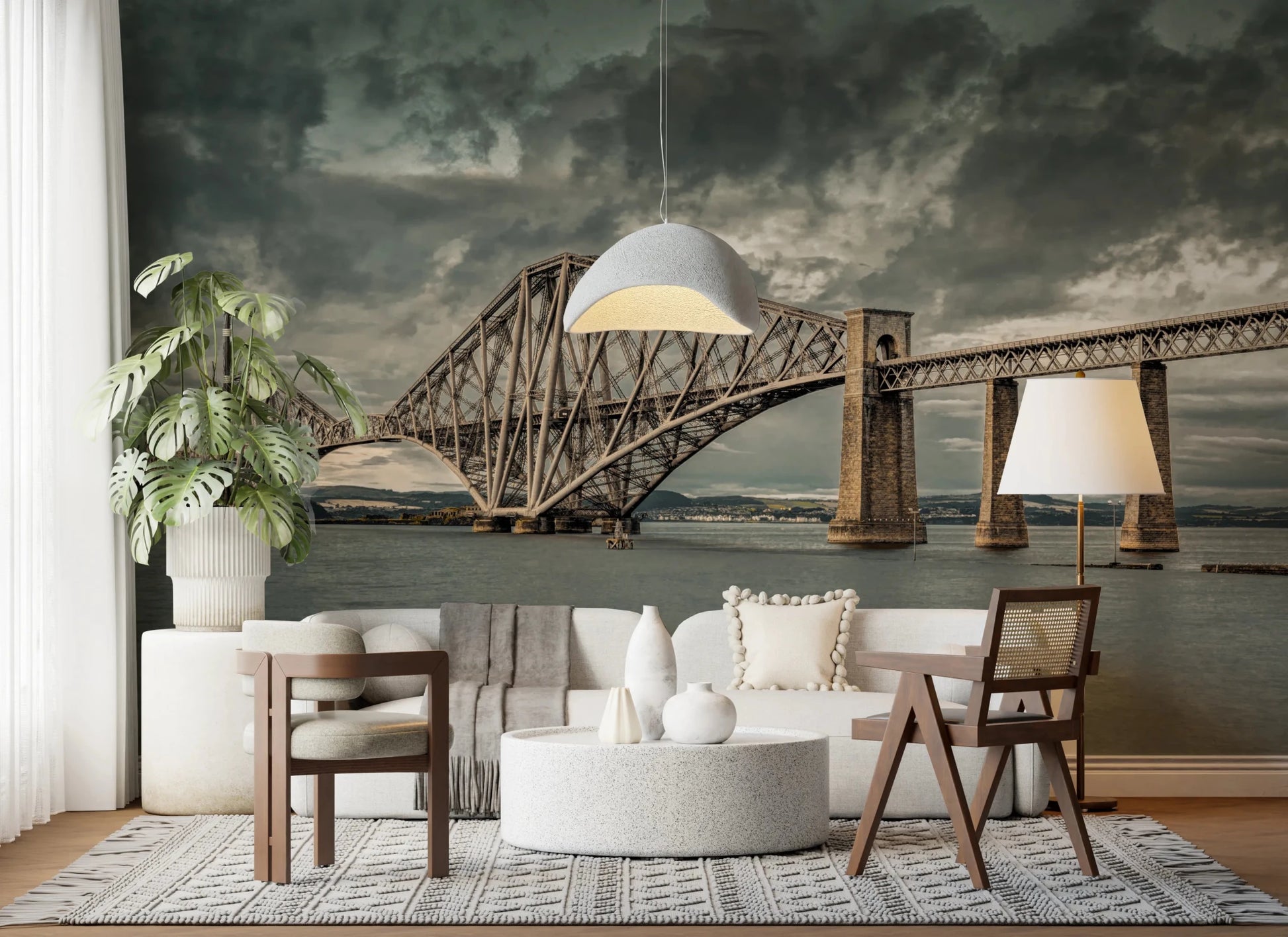 Historic Forth Rail Bridge wall mural behind a white sofa and monstera plant in a living room