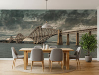 Historic Forth Rail Bridge wall mural under a stormy grey sky above a dining table and chairs